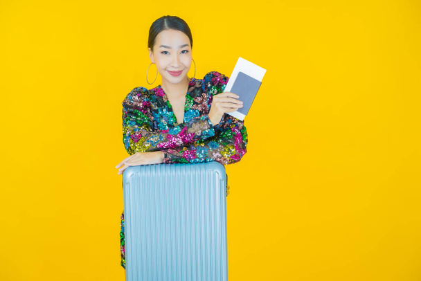 Portrait beautiful young asian woman with luggage bag and passport ready for travel - Foto, imagen