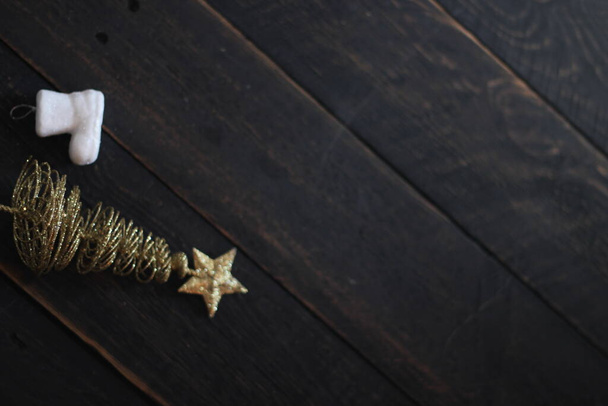 Christmas decorations placed on a black wooden table. - Fotografie, Obrázek
