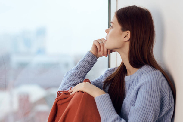 woman sitting on windowsill rest plaid morning lifestyle - 写真・画像