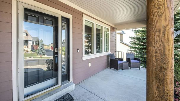 Pano Front porch of a house with engineered wood siding wall and log column post - Photo, Image