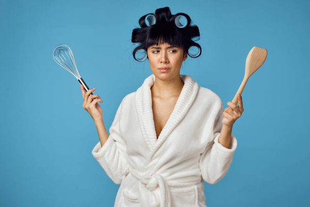 Woman in white robe kitchen utensils homework - Foto, Imagen