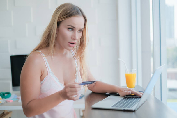 adult caucasian woman playing laptop with credit card in morning - Photo, Image