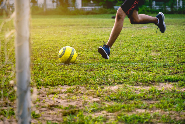 Football player training in soccer field. Young footballer practicing on football field. - Photo, image
