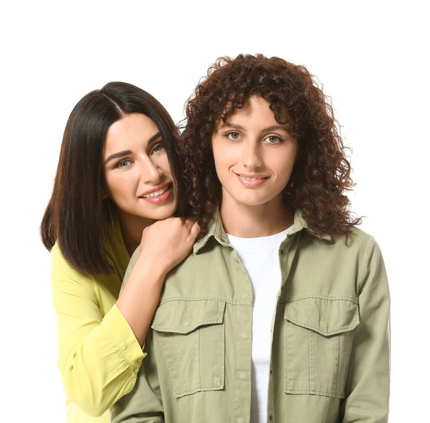 Portrait of smiling sisters on white background - Photo, Image