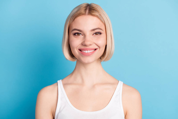 Photo of happy positive charming young lady smile face good mood wear singlet isolated on blue color background - Fotoğraf, Görsel