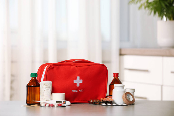 First aid kit on light grey table indoors - Fotoğraf, Görsel