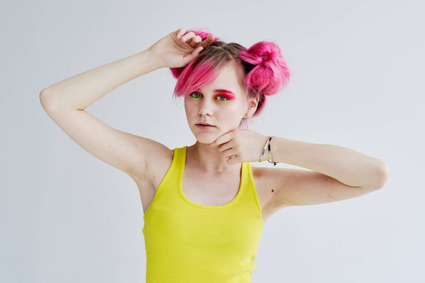 cheerful woman in yellow tank top pink hair posing lifestyle - Фото, зображення