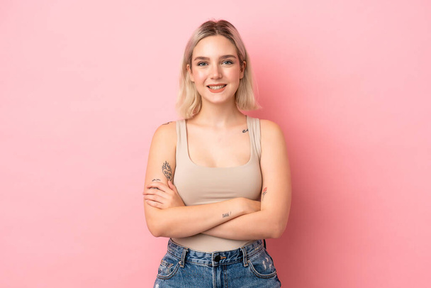 Young caucasian woman isolated on pink background keeping the arms crossed in frontal position - Photo, Image