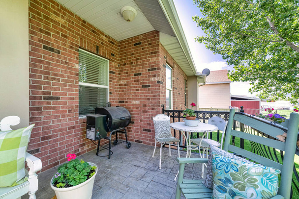 Outdoor patio on a deck of a house with chairs and barbecue grill - Photo, Image