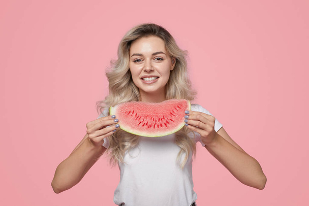 Happy young lady with watermelon slice in hand smiling at camera - Foto, Imagem