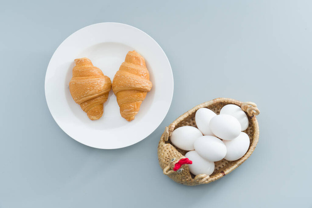 A nutritious breakfast with eggs and croissants - Photo, Image
