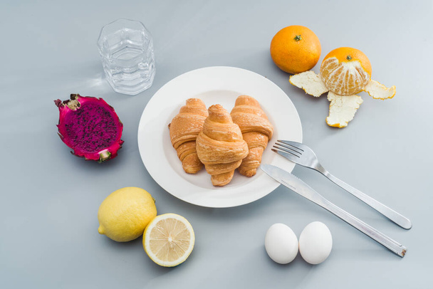 A nutritious breakfast with croissants and fruit - Fotoğraf, Görsel