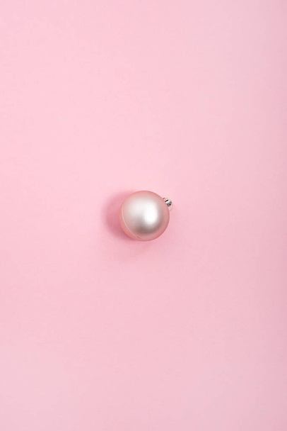 Egy dekoratív rózsaszín labda rózsaszín háttérrel. Felülnézet, lapos fektetés - Fotó, kép