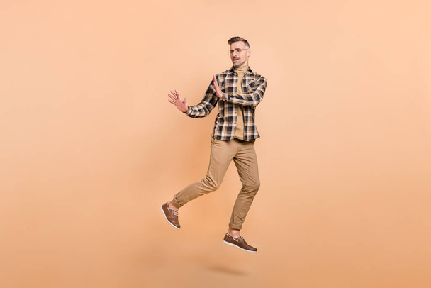 Full size photo of mature man jump demonstrate arms no stop symbol look empty space isolated over beige color background - Фото, зображення