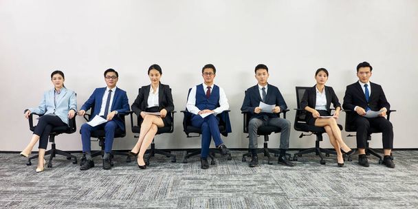 asian business people waiting in line for job interview looking at camera - Photo, Image