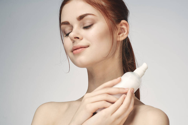 woman with bare shoulders cosmetics procedures skin care cream - Foto, imagen