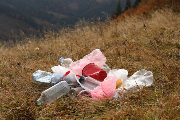 Pile of plastic garbage on grass in nature - Fotoğraf, Görsel