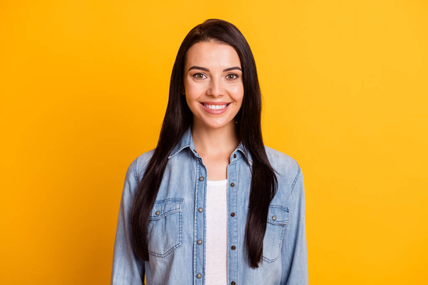 Portrait of nice optimistic brunette lady wear blue shirt isolated on bright yellow color background - Foto, Imagem