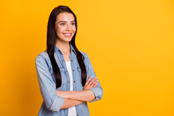 Profile portrait of nice optimistic brunette lady crossed arms look empty space wear blue shirt isolated on bright yellow color background - Foto, immagini