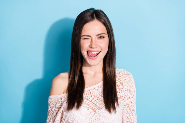 Photo of funky flirty young woman lick teeth tongue wink eye smile isolated on blue color background - Valokuva, kuva