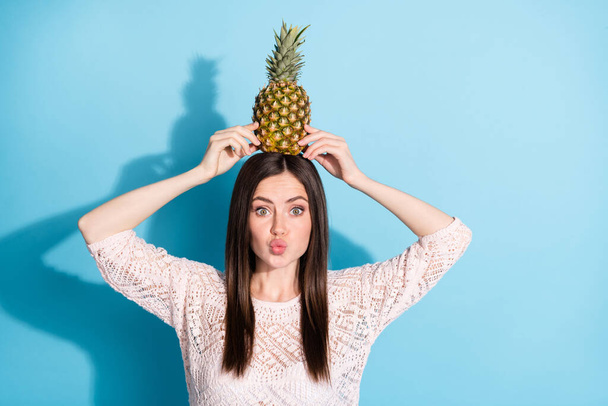 Photo of pretty beautiful young woman send air kiss hold pineapple head isolated on blue color background - Foto, Imagem