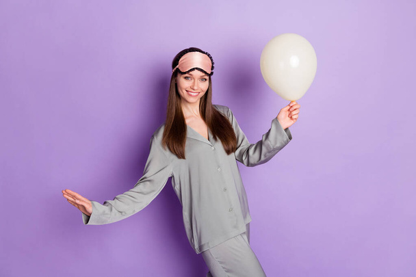 Photo portrait of girl in pajama sleeping mask keeping balloon preparing for birthday isolated on pastel purple color background - Fotoğraf, Görsel