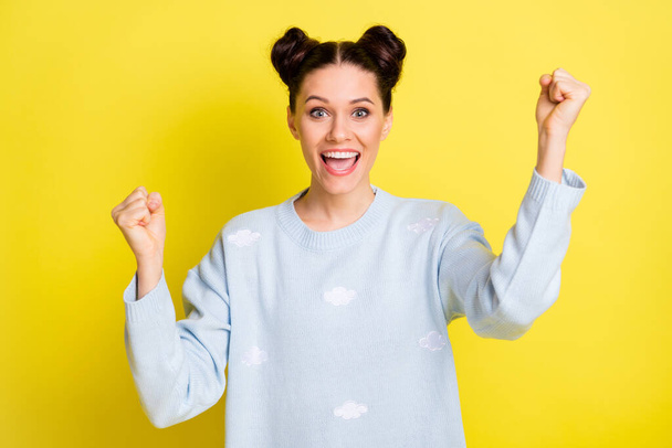 Photo of cheerful astonished lady raise fists open mouth wear blue pullover isolated yellow background - Фото, зображення