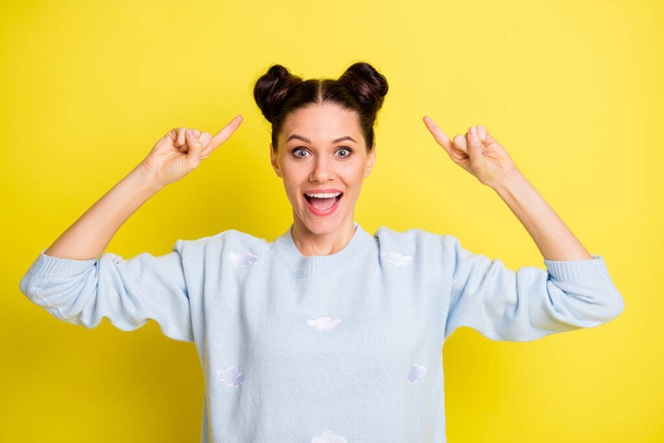 Portrait of attractive amazed girlish cheerful girl demonstrating hairdo coiffure having fun isolated over bright yellow color background - Photo, Image