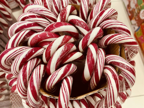 Candy canes with red and white stripes in the supermarket - Photo, Image