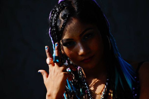 A stylish Indian female with dreadlocks posing at camera - Zdjęcie, obraz