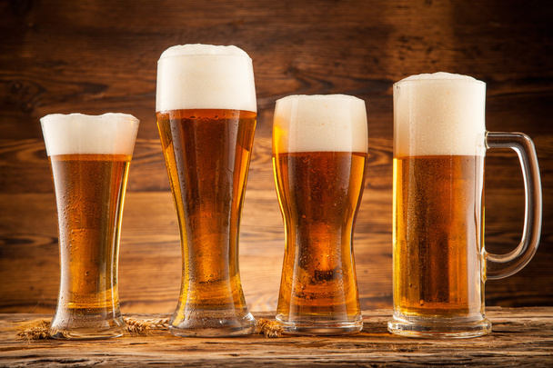 Glasses of beer on wooden planks - Фото, зображення