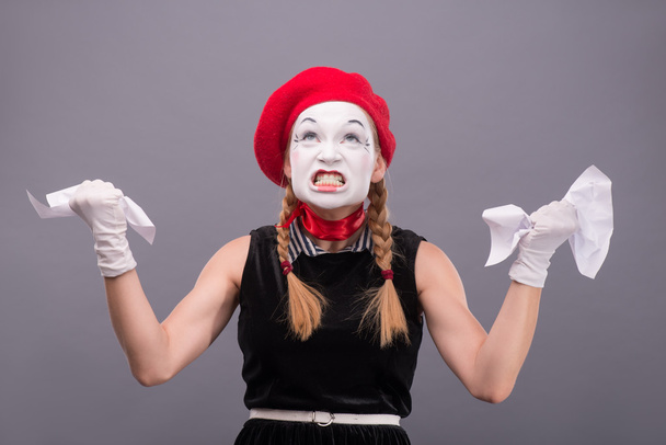 Female mime angry crumpling a paper - Фото, зображення
