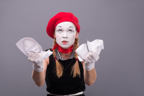 Female mime angry crumpling a paper - 写真・画像