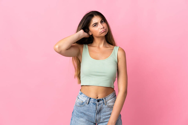Young caucasian woman isolated on pink background having doubts - Photo, Image