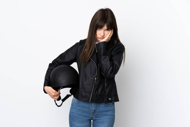 Woman holding a motorcycle helmet isolated on white background unhappy and frustrated - Φωτογραφία, εικόνα
