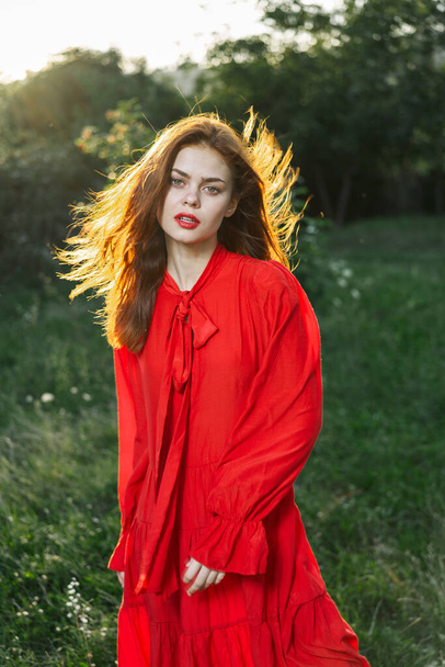 attractive woman in red dress outdoors in freedom field - Φωτογραφία, εικόνα