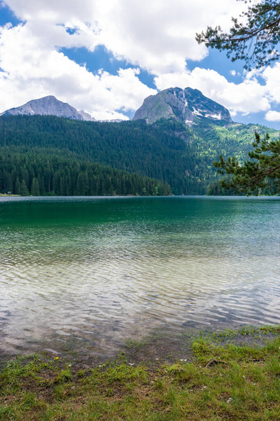 Glacial Black Lake, with Meded Peak. Lake is premium tourist attraction of Durmitor National Park. Walking path circles around lake, and it is popular destination for recreation and hiking. Montenegro - 写真・画像