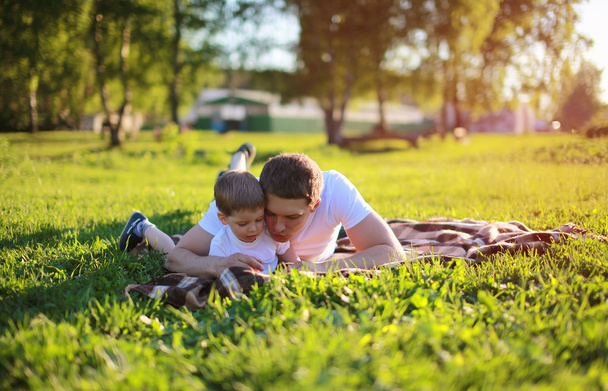 Father and son lying on the grass in weekend, family, vacation,  - Photo, image