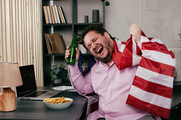 Funny fat man drinking beer at home. - Fotó, kép