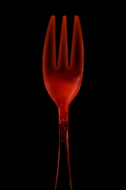 fork, red-hot, triple, small size, stolen view, on black background. - Foto, Imagen