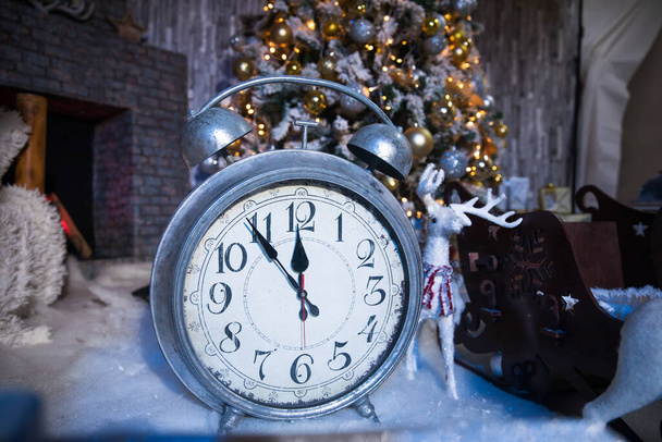 Christmas background. Alarm clock and christmas light - Photo, image