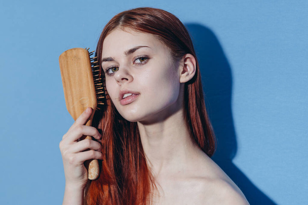 redhead woman naked shoulders hair care blue background - Foto, Imagem