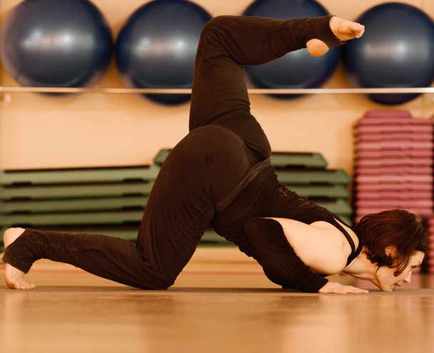 Brunette woman doing yoga exercises - Fotoğraf, Görsel