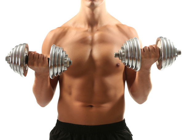 Handsome young muscular sportsman execute exercise with dumbbells isolated on white - Foto, immagini