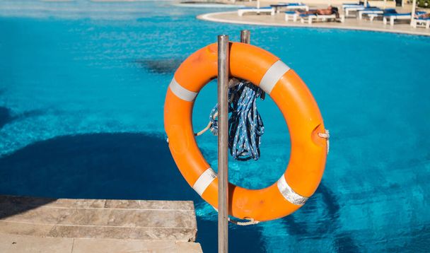 Lifebuoy by the pool, safety first.  - Photo, Image