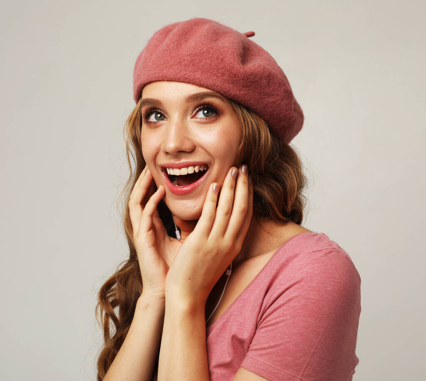 Close-up portrait of nice attractive lovely gorgeous cheerful girlish wavy-haired woman wearing pink hat and shirt enjoying expecting sale give away isolated on grey color background - Foto, afbeelding