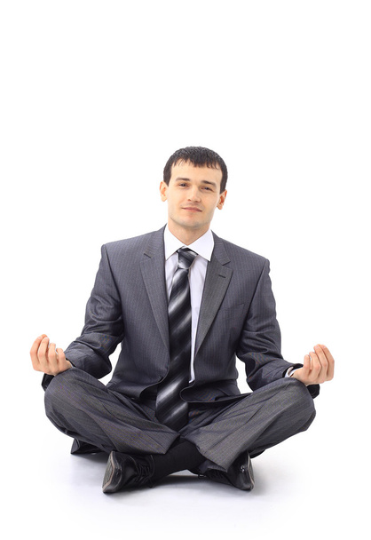 Photo of relaxed businessman meditating over white background - Foto, imagen