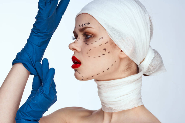 female patient in blue gloves syringe in hands contour on the face lifting isolated background - Foto, Imagem