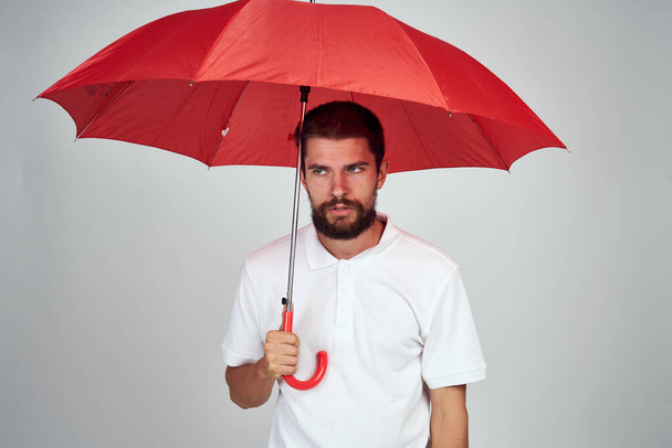 man with umbrella in hands emotions posing light background - Fotografie, Obrázek