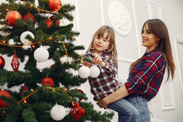 Mother with cute daughter at home with christmas gifts - Fotografie, Obrázek